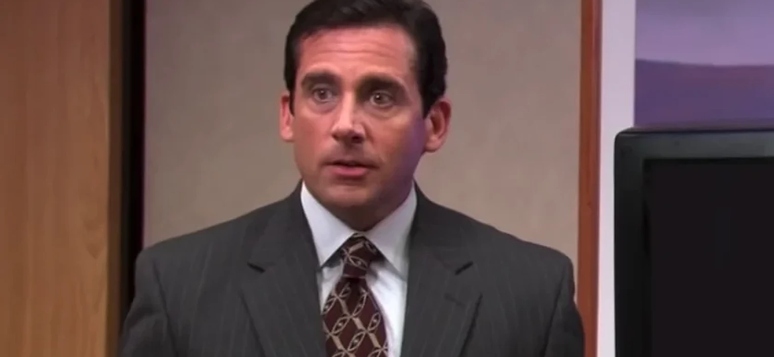 Michael Scott presenting in the conference room, from the Launch Party cold open